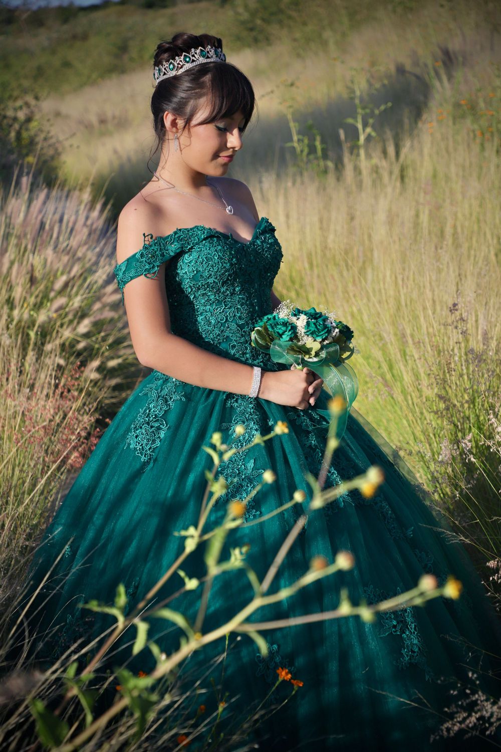Sparkling emerald green ball gown with sequins photographed in golden field.