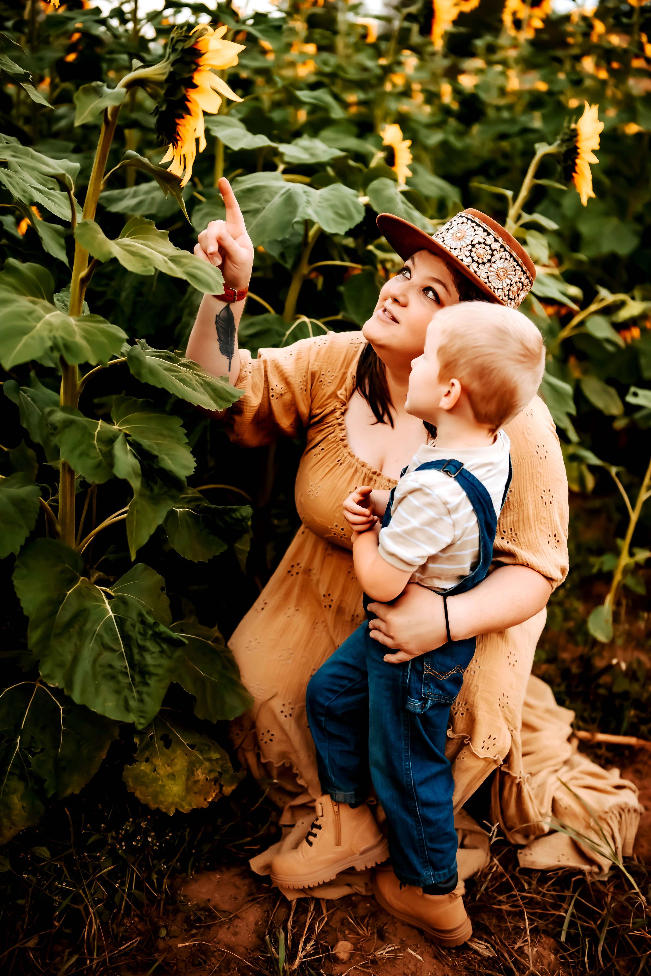A tender moment captured in a sunflower field at golden hour.
