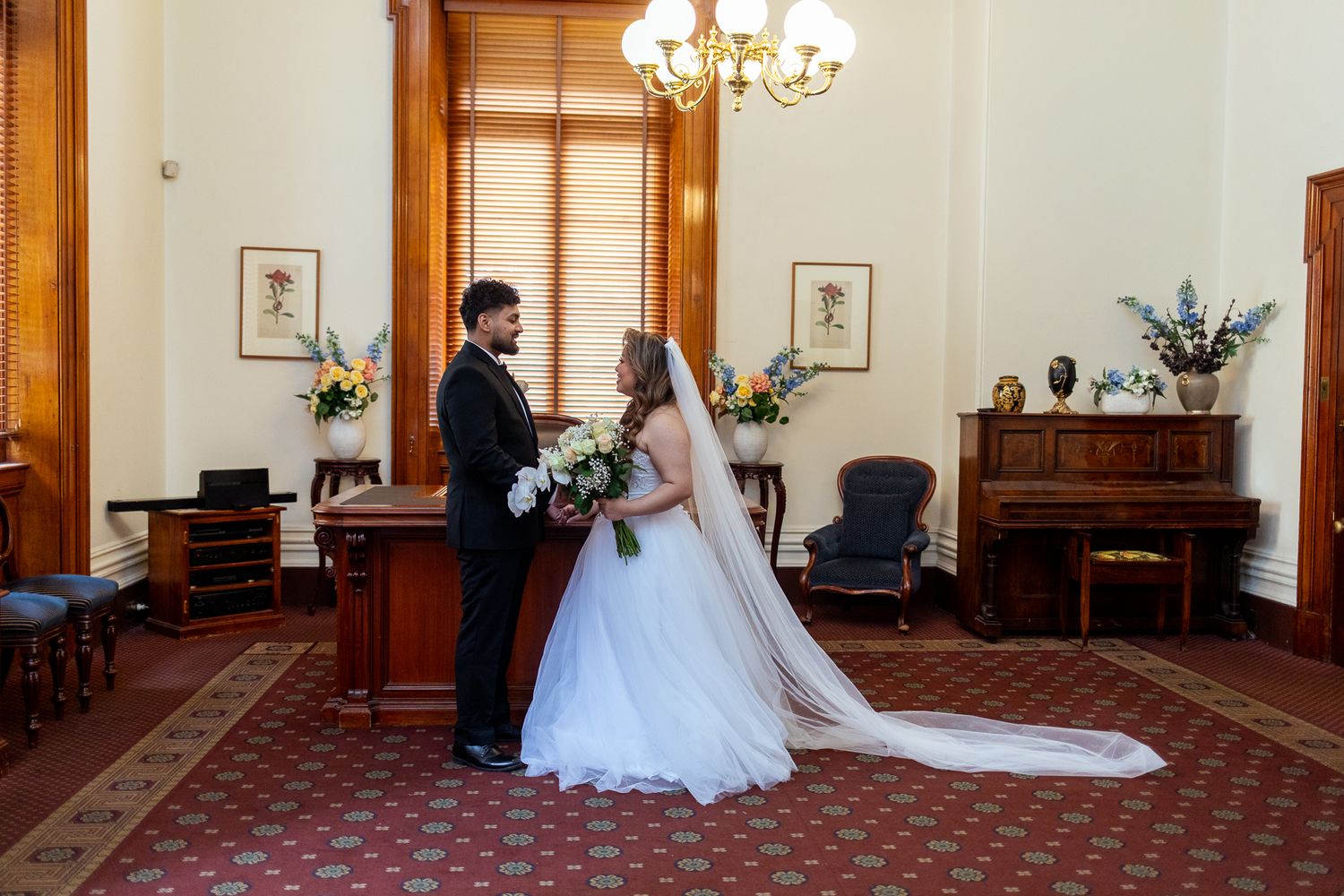 Couple holding hands inside Treasury Buildings during marriage ceremony, Melbourne.