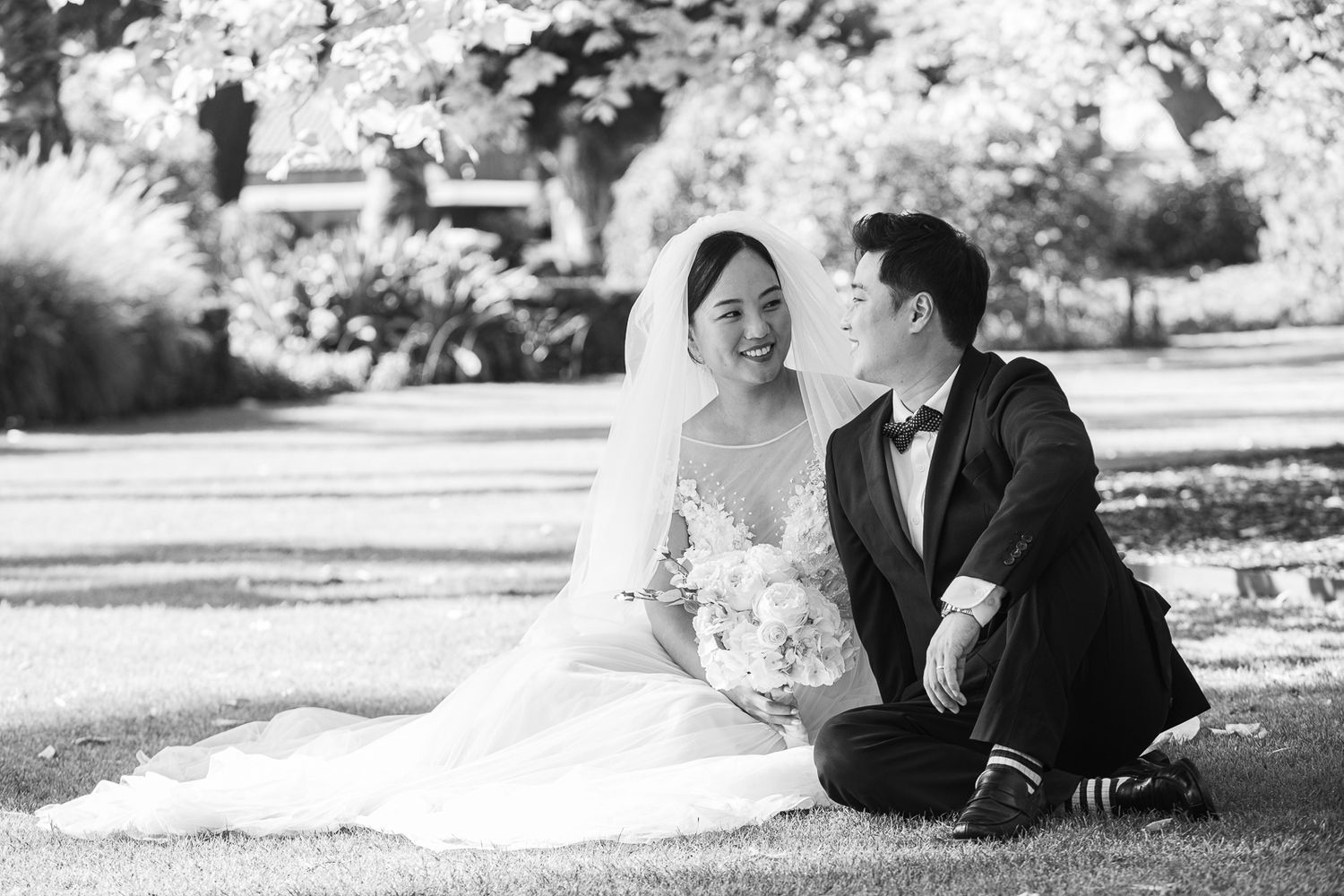Melbourne photographer captures a relaxed bride and groom enjoying a moment on the lawn after their wedding ceremony.
