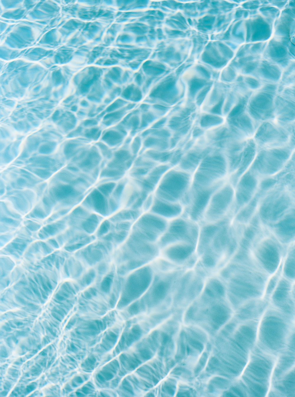 Water surface with ripples and waves in a pool at a wedding pool party in Tuscany, Italy.
