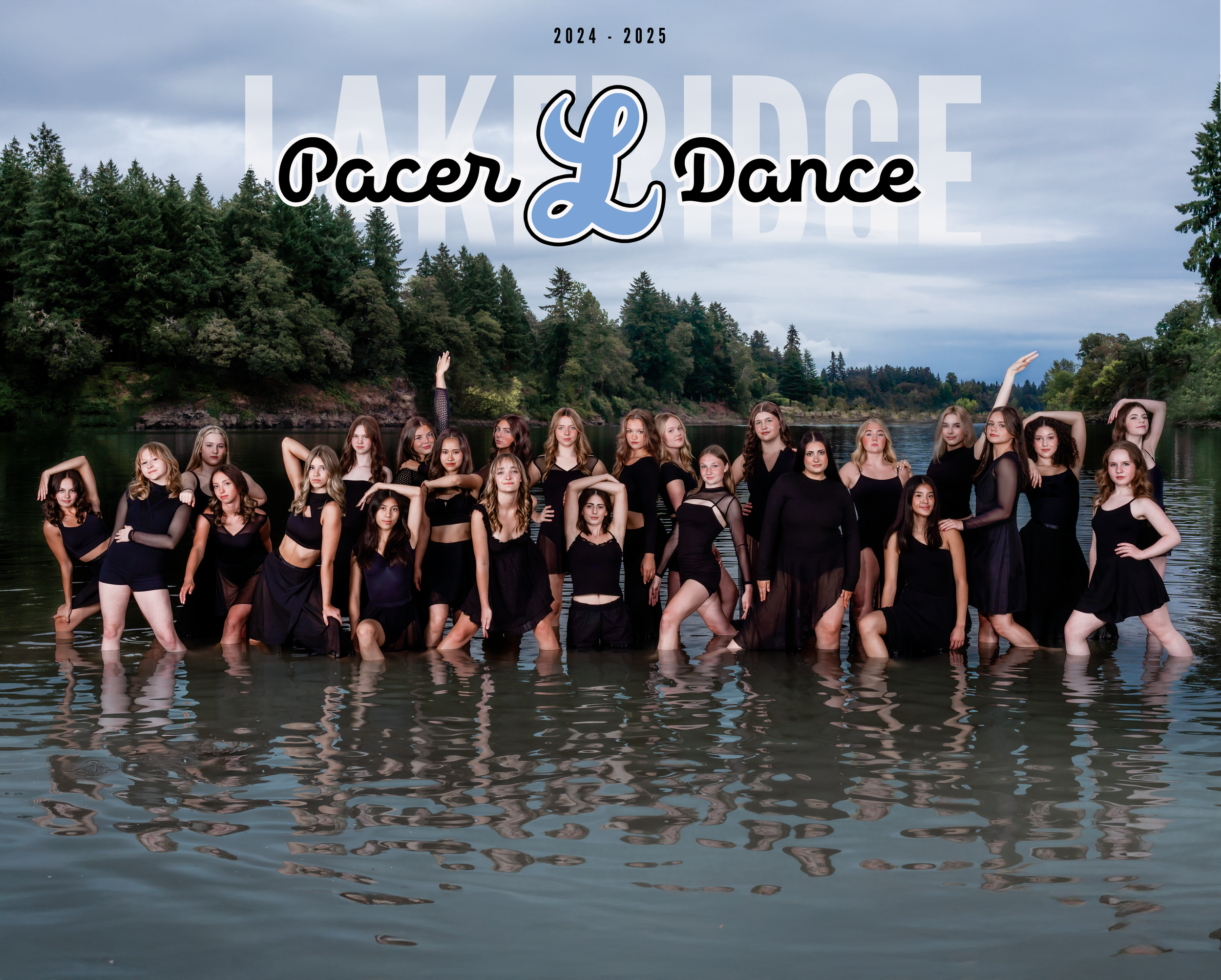 Lakeridge High School Dance Team poses in black outfits while standing in lake water with pine forest and mountains in background.