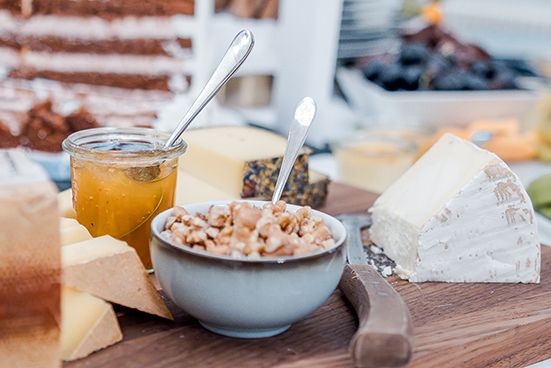 A close-up view of various breakfast foods and beverages arranged on a wooden table.