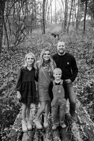 Black and white family photo on their farm, capturing timeless and heartfelt moments in a rustic, natural setting.
