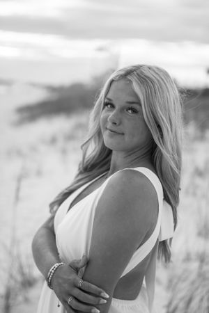Senior portrait session on the beach, capturing a client’s unique style and personality with a beautiful coastal backdrop.