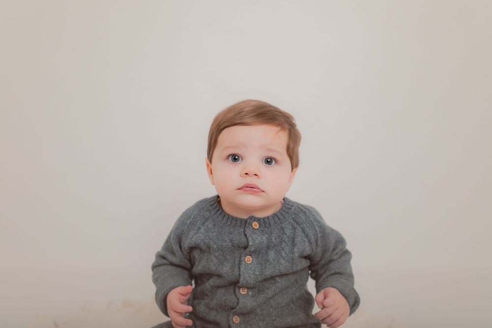 Baby wearing grey outfit during professional studio photography session. Photographer. Hull. East Yorkshire. Photography