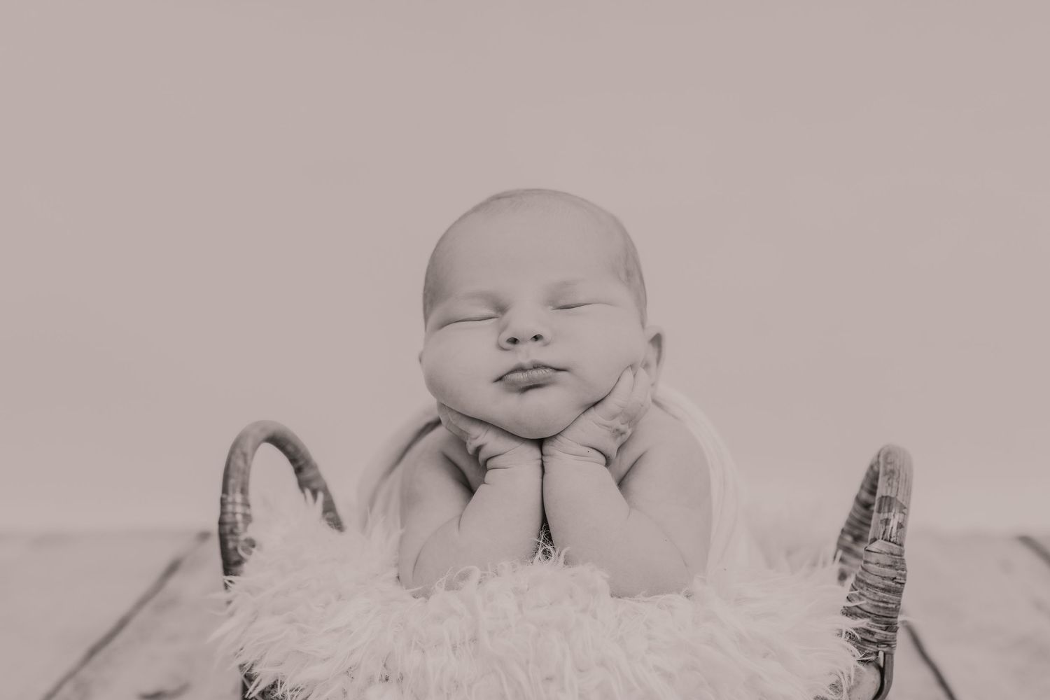 Sleeping newborn baby wrapped in soft white blankets against neutral background. Photographer. Hull. East Yorkshire. Photography