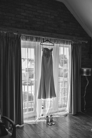 A sequence of black and white photos showing curtains and natural light in an attic room with wooden floors.