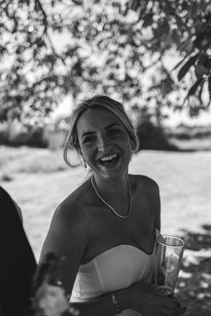 Black and white sequence of candid photos showing joyful laughter in dappled sunlight.