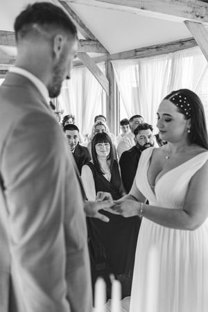 A couple shares an emotional first dance at their wedding reception while guests watch from the sidelines.