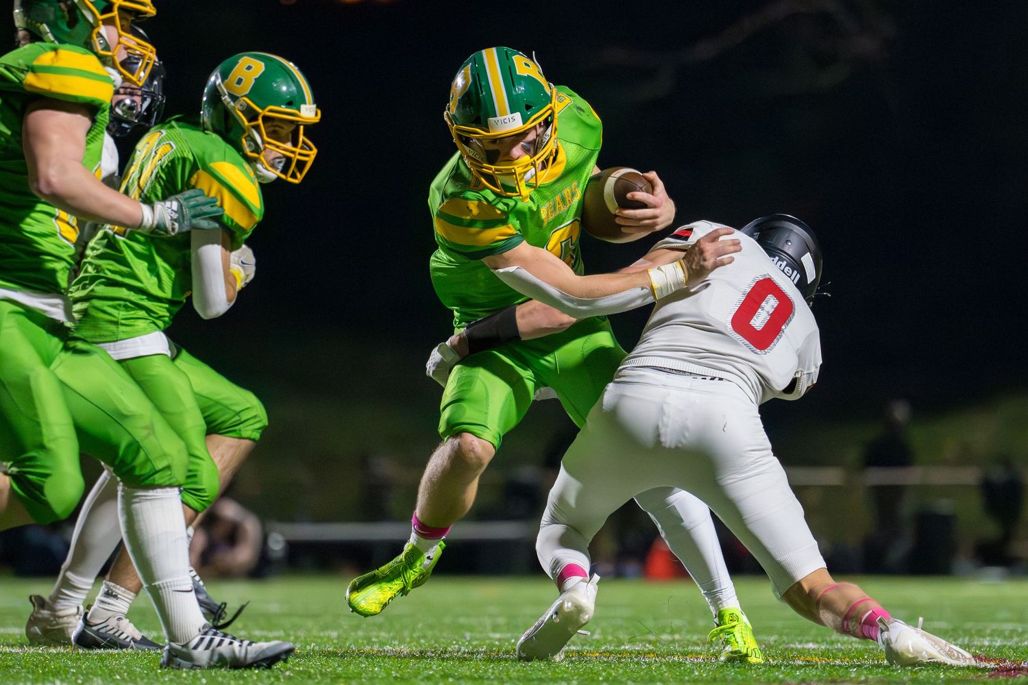 A football player from Bishop Blanchet High School breaks a tackle attempt.