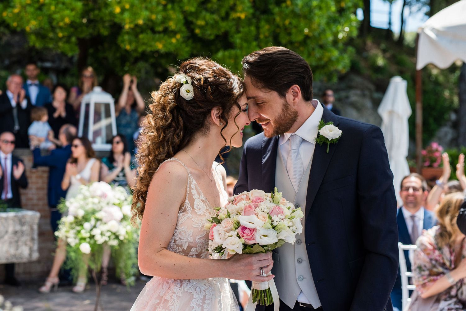 Romantic wedding celebration moments captured in a series of outdoor photographs.