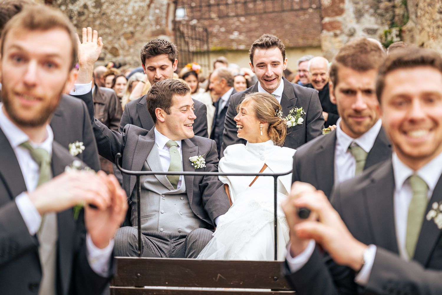 Wedding celebration with guests taking photos of the happy couple.