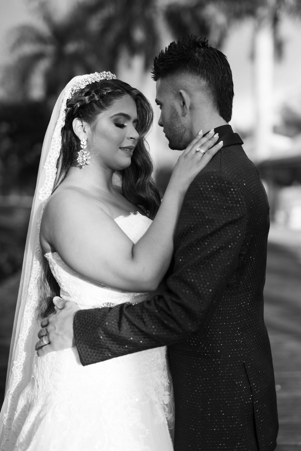 Intimate black and white portrait of newlyweds sharing tender moment.