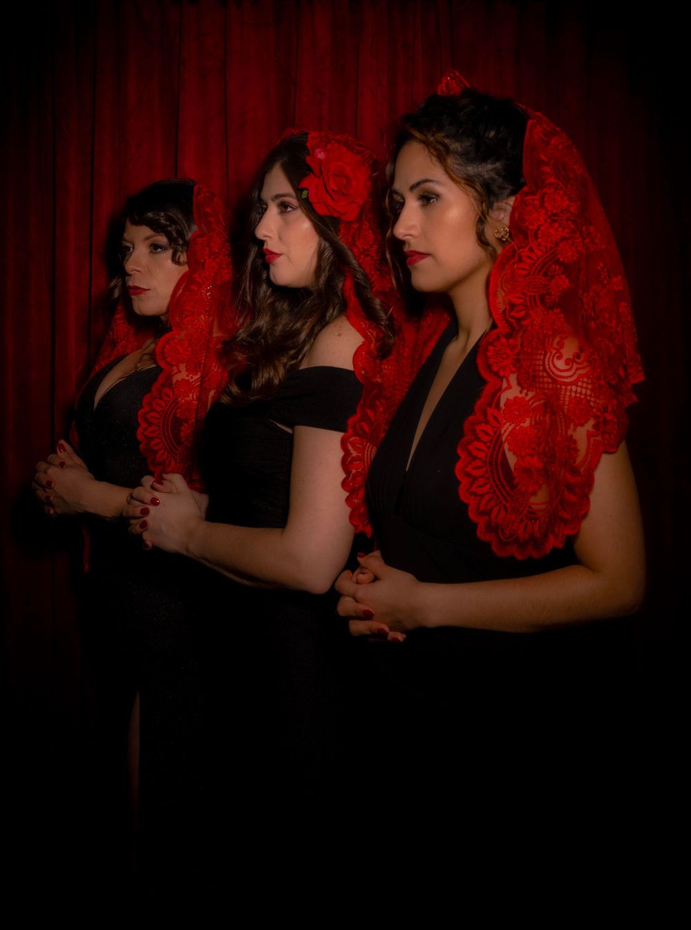 A series of dramatic silhouettes against a red backdrop show figures in intimate dance poses with flowing hair.
