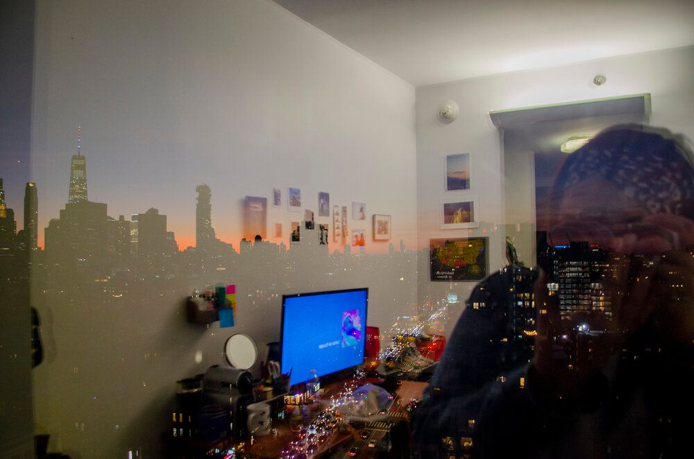 City skyline silhouette painted on wall with desk and computer setup.