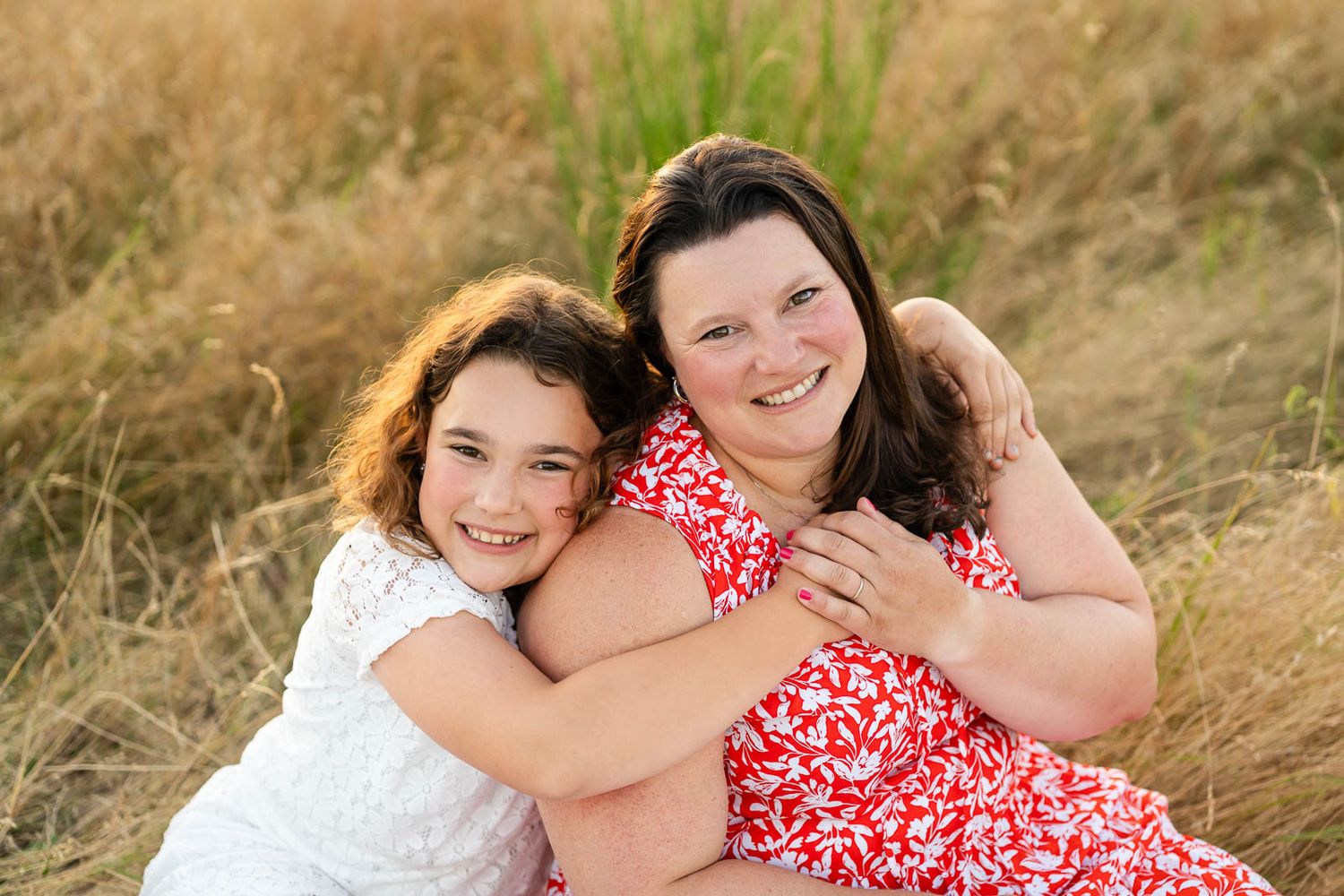 Mother daughter hold hands for posed portrait at Marymoor Park