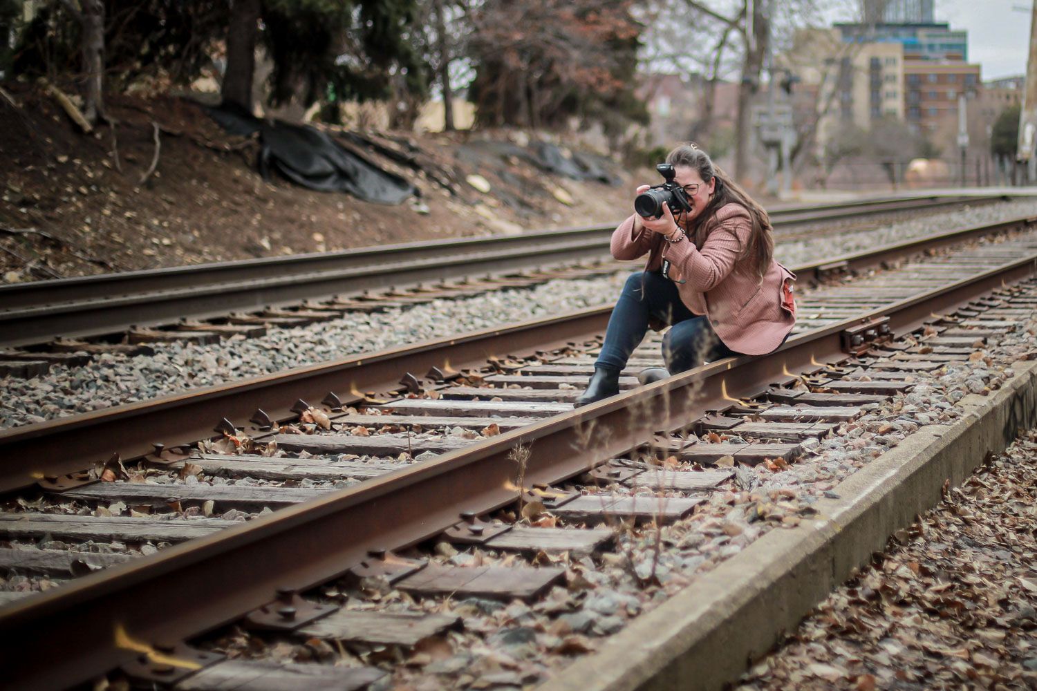Photo of Heather taking a photograph on the railroad