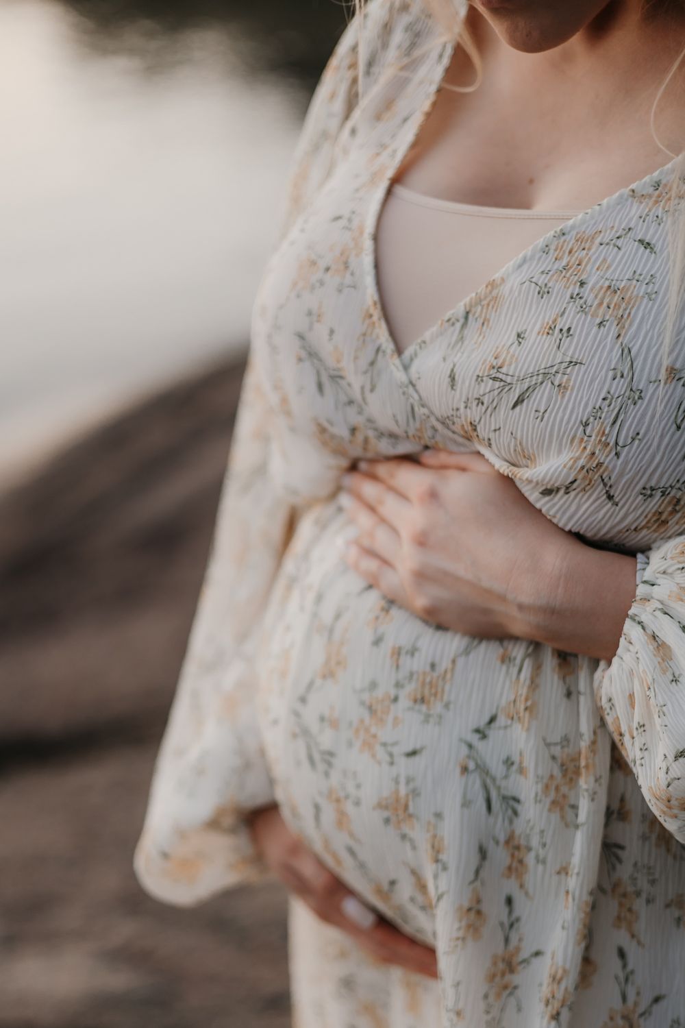 Close-up details of delicate floral patterned dress in soft natural lighting.