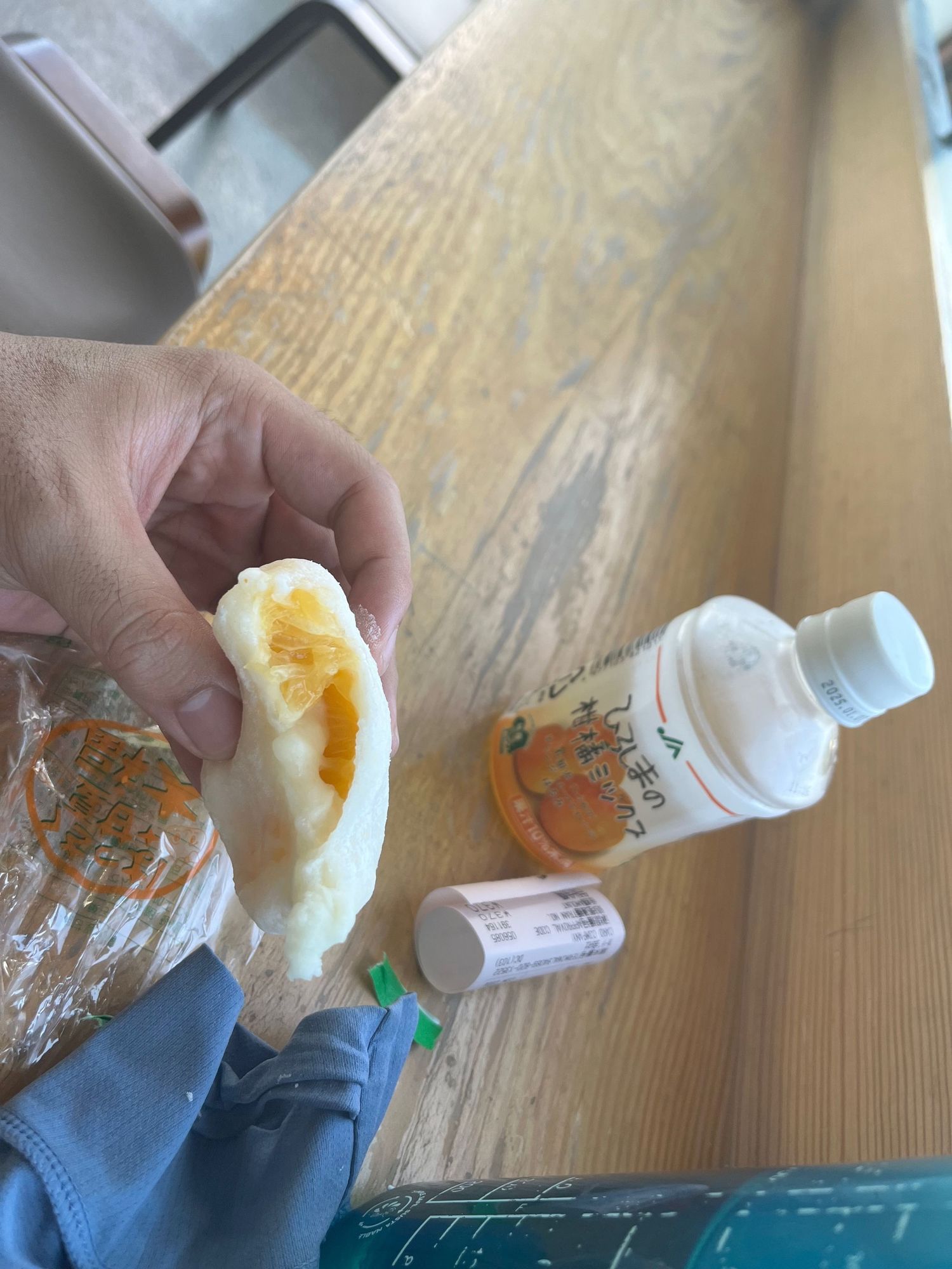 Close-up sequence of someone squeezing a white tube of food product onto a wooden surface.
