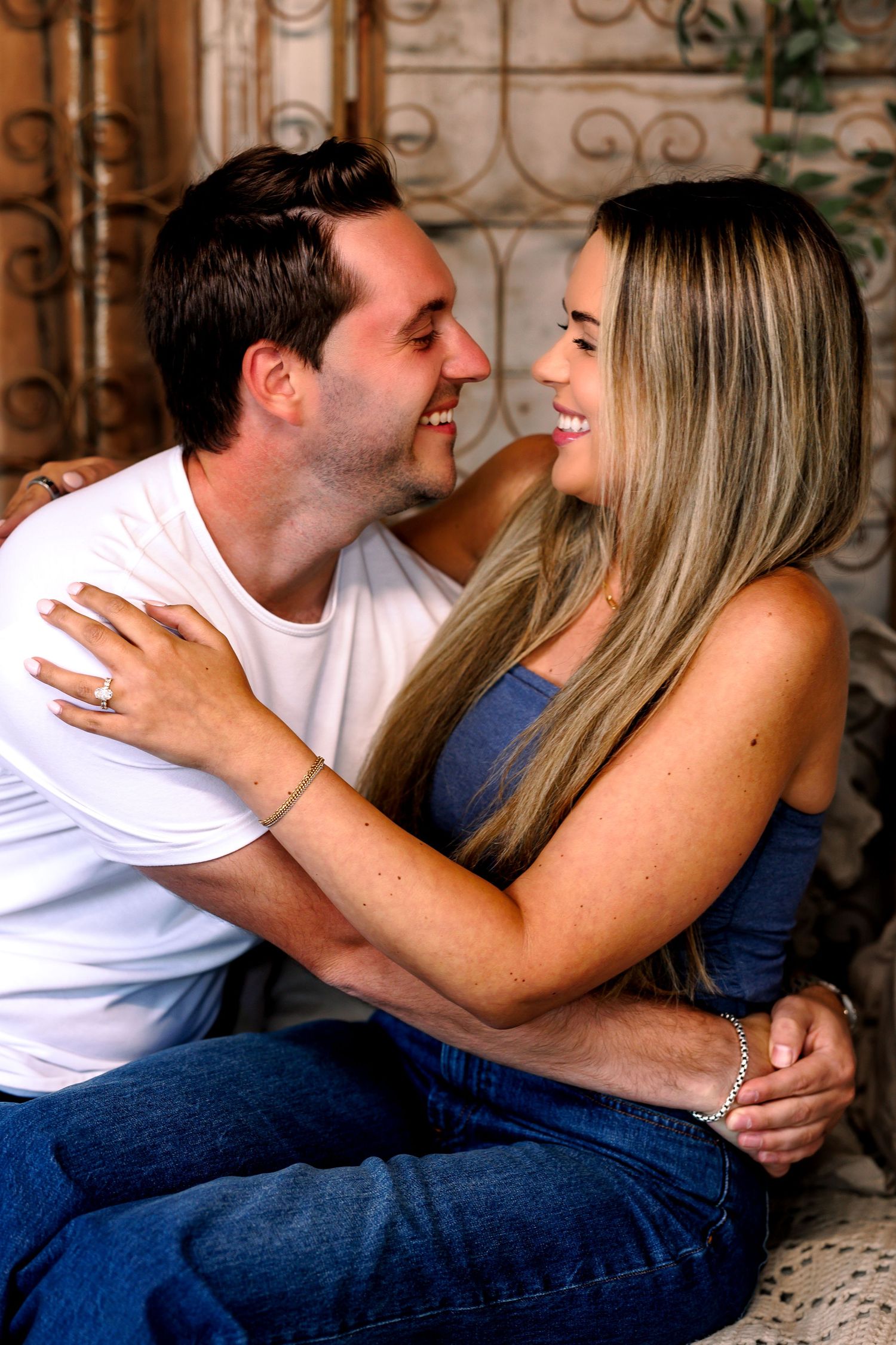 Romantic couple photo series showing intimate moments while lying on textured floor.