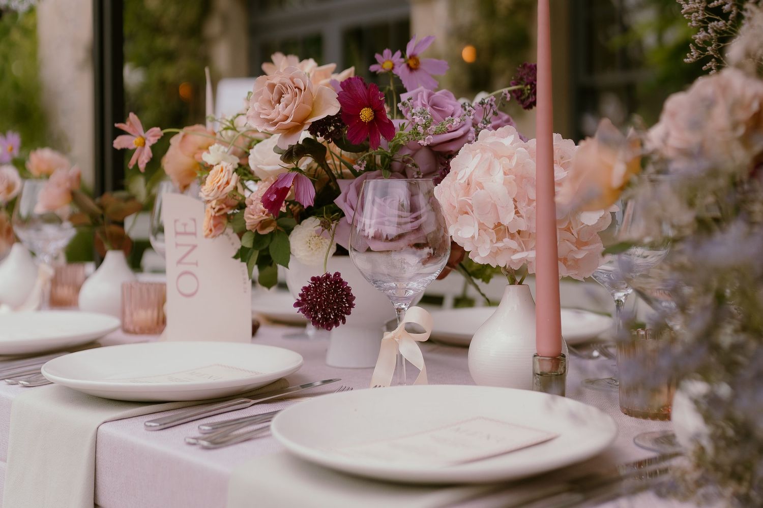 A romantic wedding table decorated with pink roses, orchids and crystal glasses at Middleton Lodge.