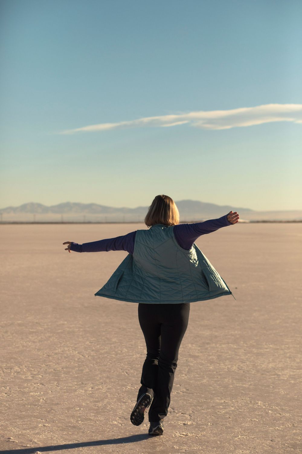 Alison of Lumenali Photography spins and runs on the salt flats in Salt Lake City, Utah.
