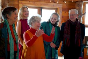 Small group enjoying laughter and conversation at wedding celebration.