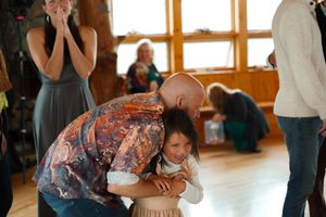 Emotional wedding guests share hugs and reactions during a touching moment at the celebration.