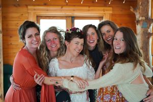 A joyful group moment captured in a wooden room with string lights.
