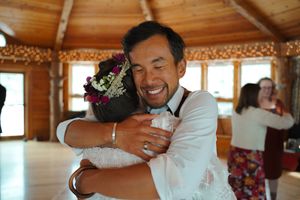 Participants sharing embraces during an emotional moment at a group workshop.