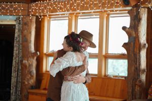Rustic lodge interior with string lights and large windows creating an intimate dance atmosphere.