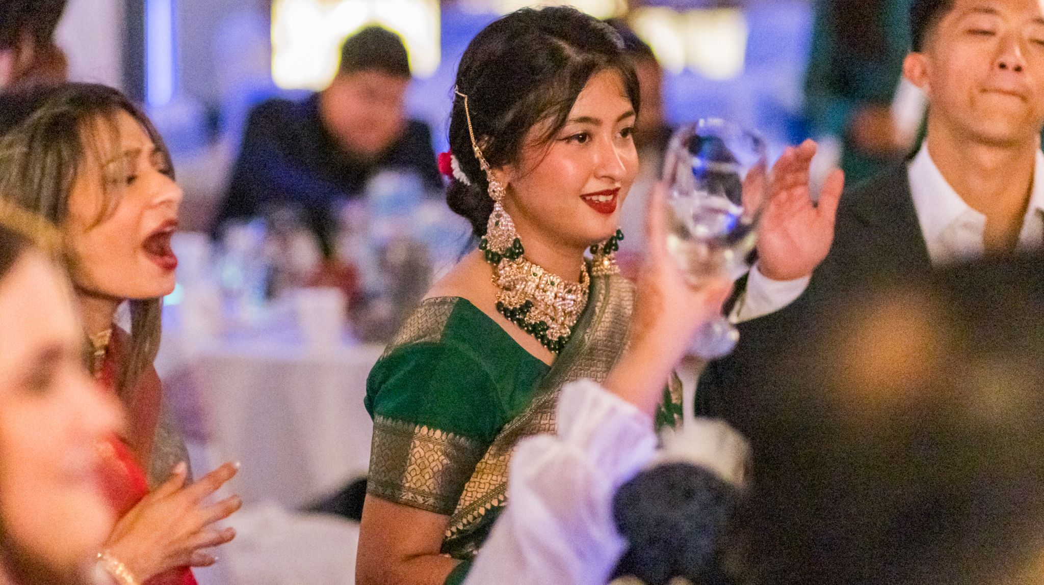 Guests enjoying and celebrating at an elegant reception with traditional attire.
