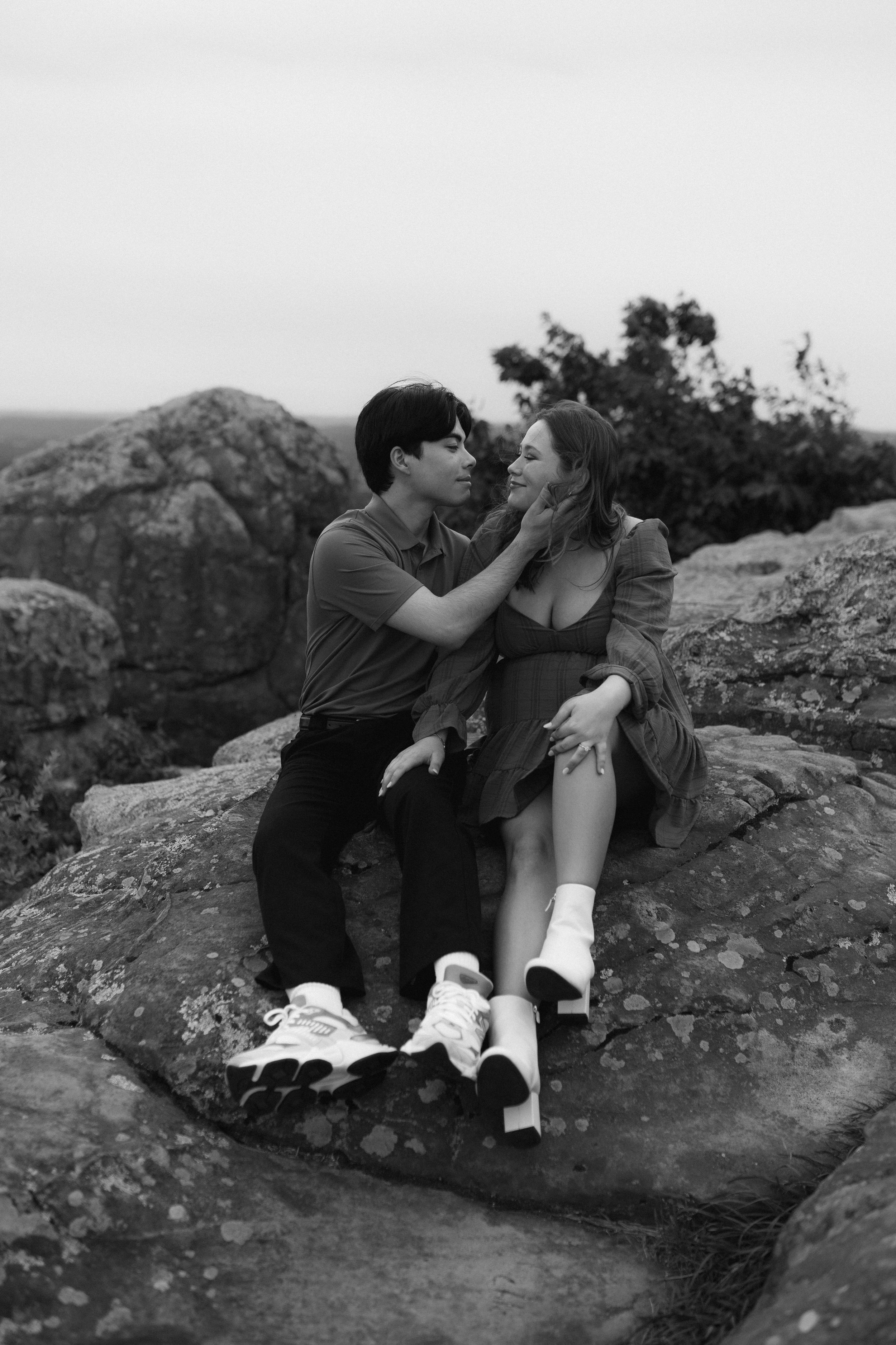 Intimate black and white portrait session on rocky terrain.