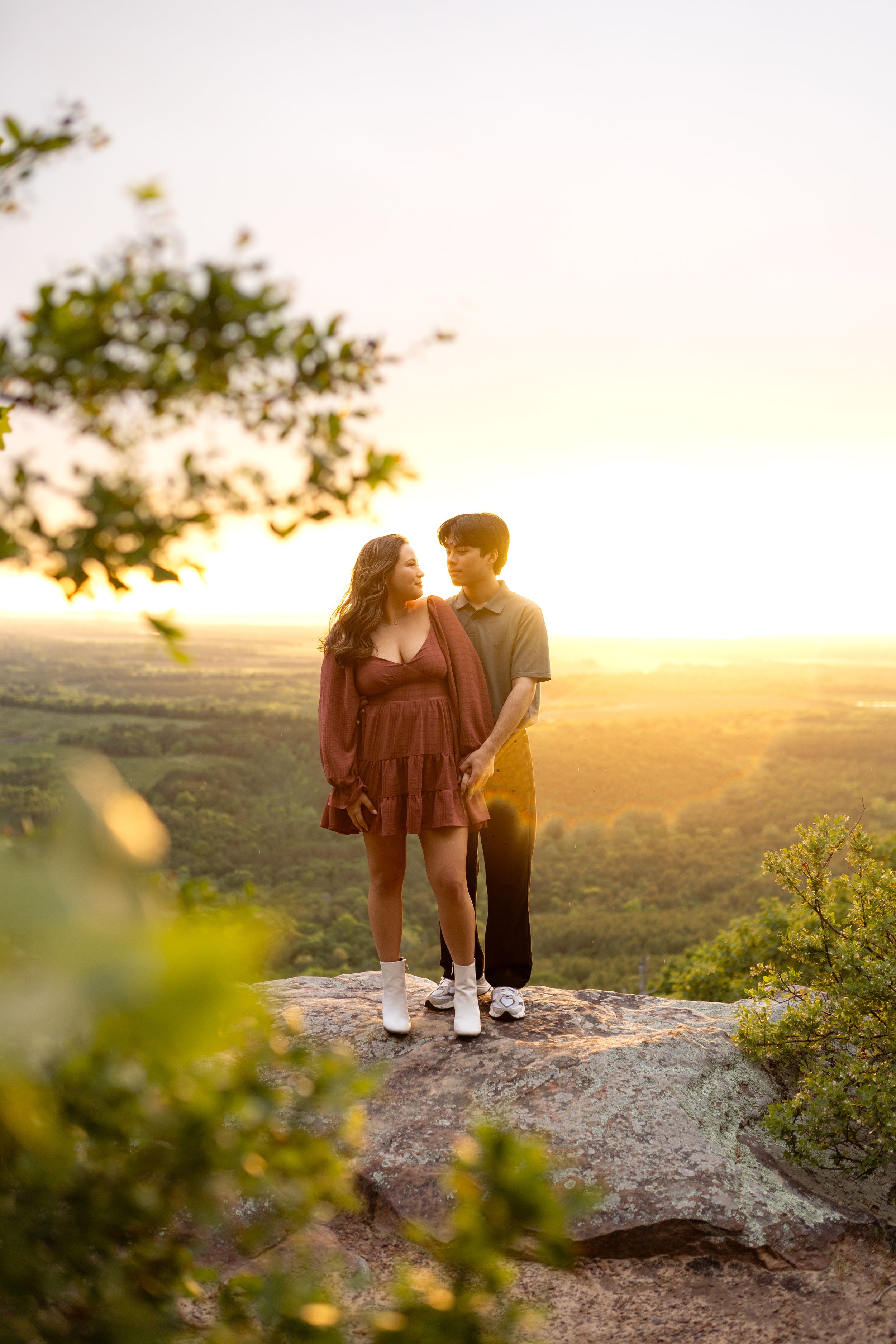 Romantic sunset portrait session on a scenic cliff overlook.