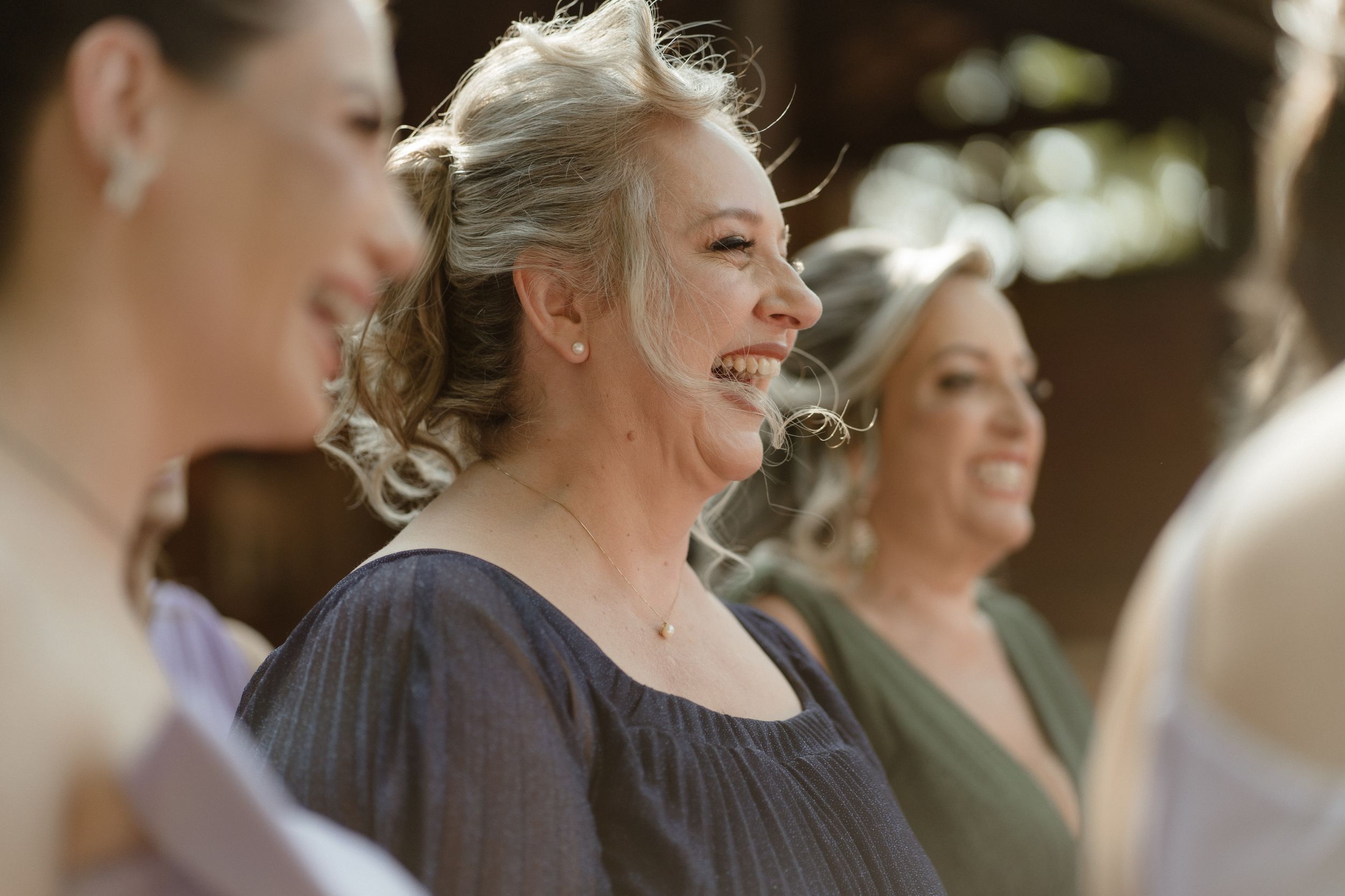 Candid moment of joyful laughter during wedding celebration.