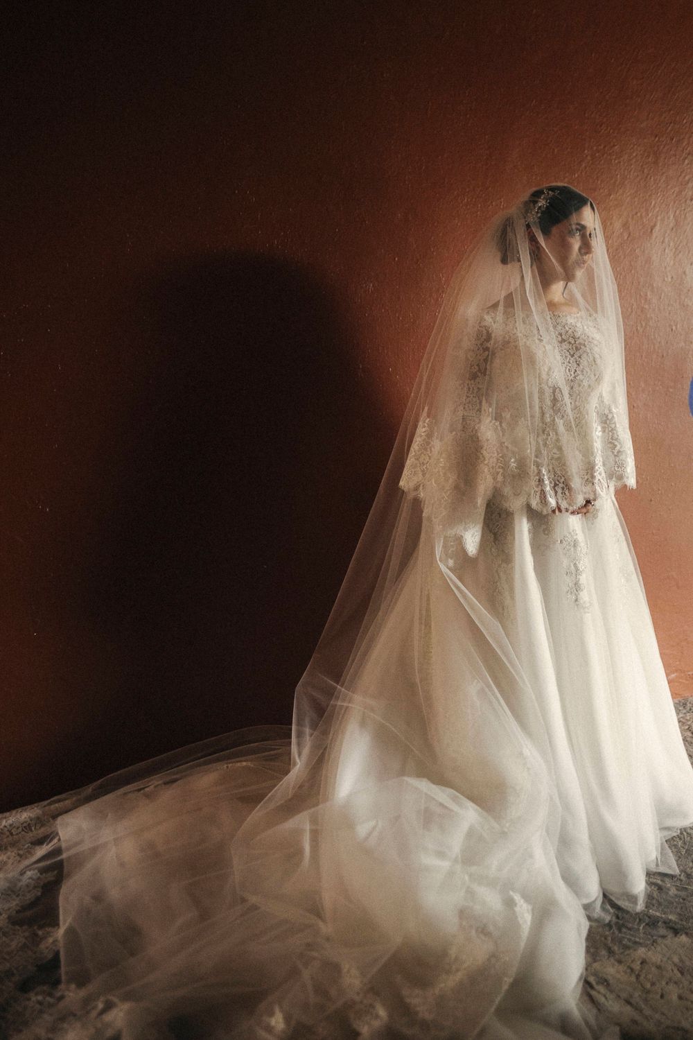 Artistic series showcasing a flowing white wedding dress with intricate lace details against dark background.