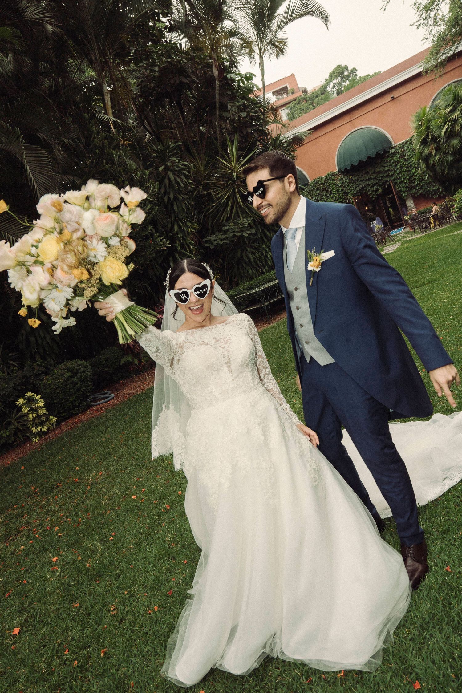 Wedding sequence showing couple walking through lush garden grounds with white floral bouquet.