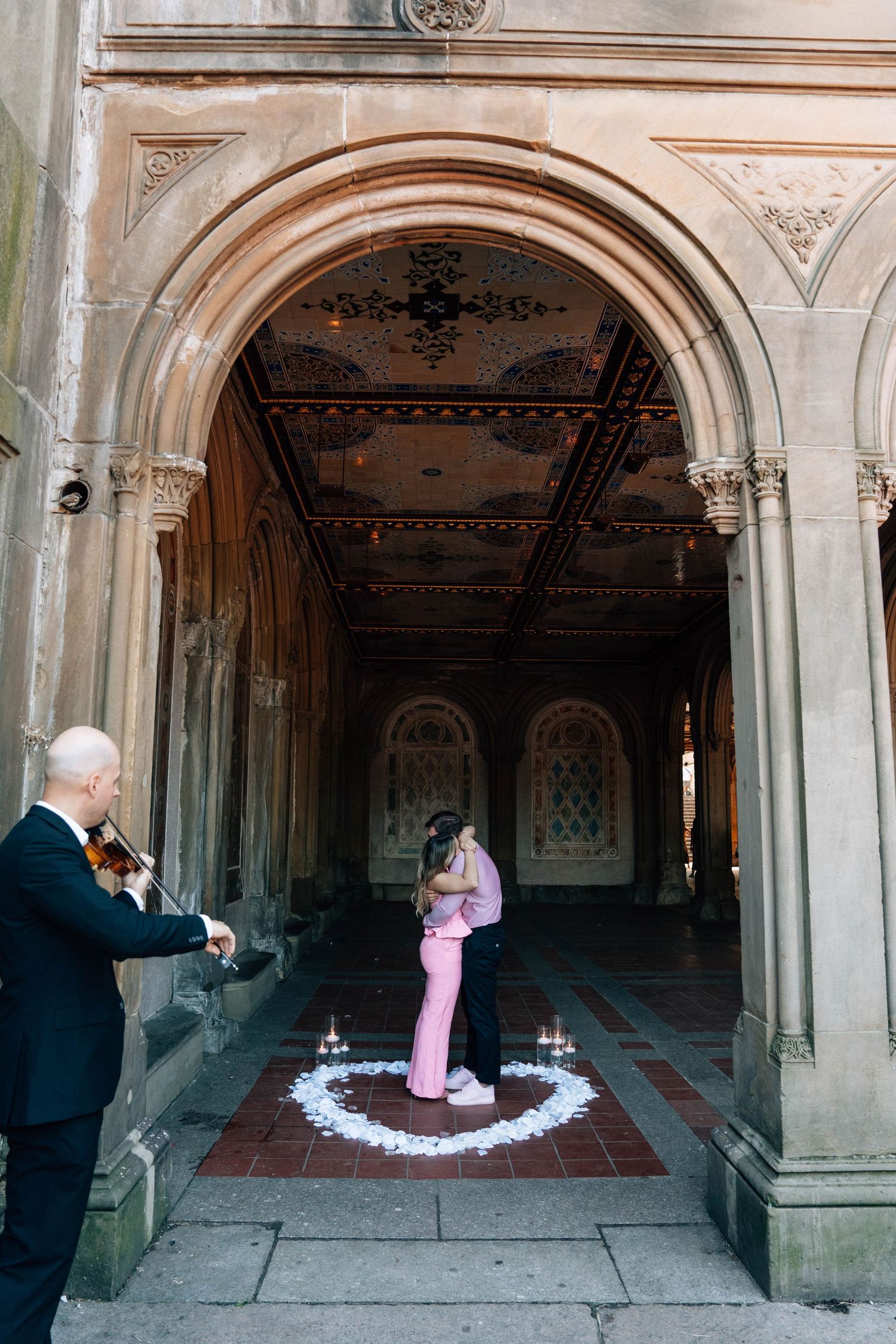 Marriage proposal moment at rustic wooden gazebo overlooking lake in Central Park.