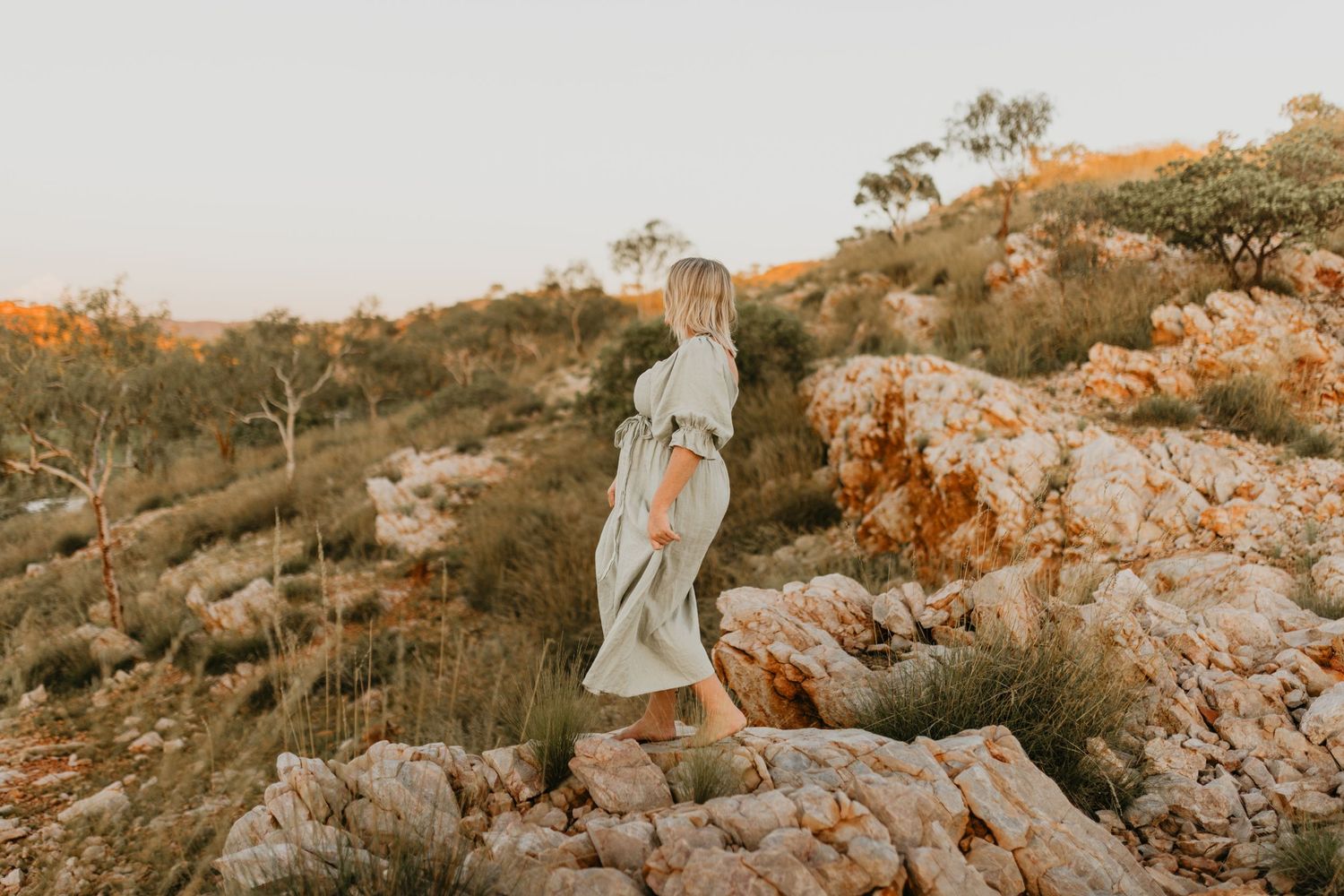 Woman standing on rocky cliffs at Lake Moondarra, Mount Isa