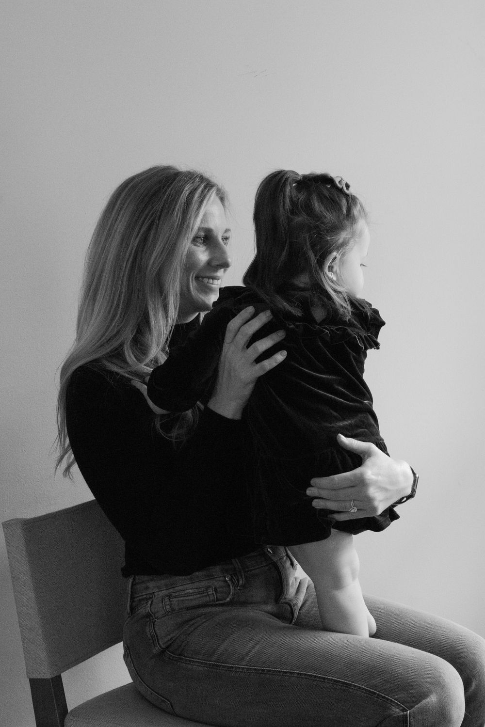 A tender moment between family members shown in black and white against a plain background.