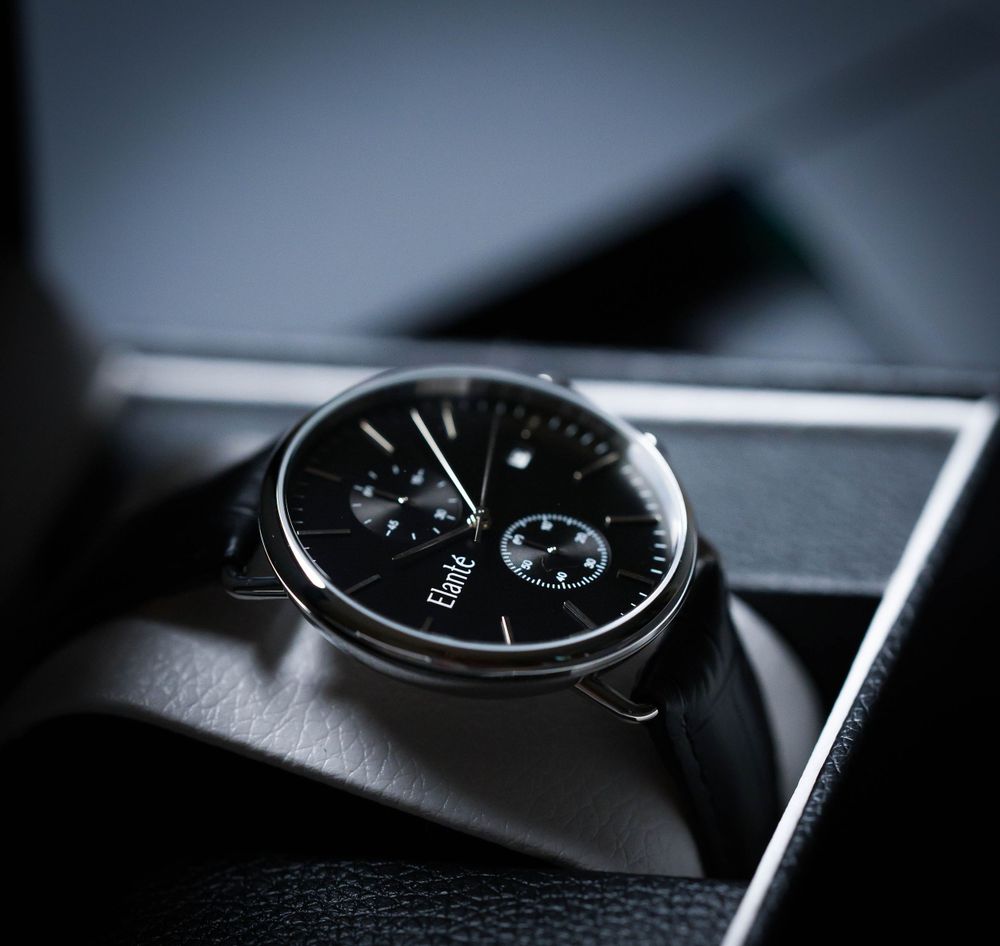 Nice black wrist watch stages in its box for a product shoot
