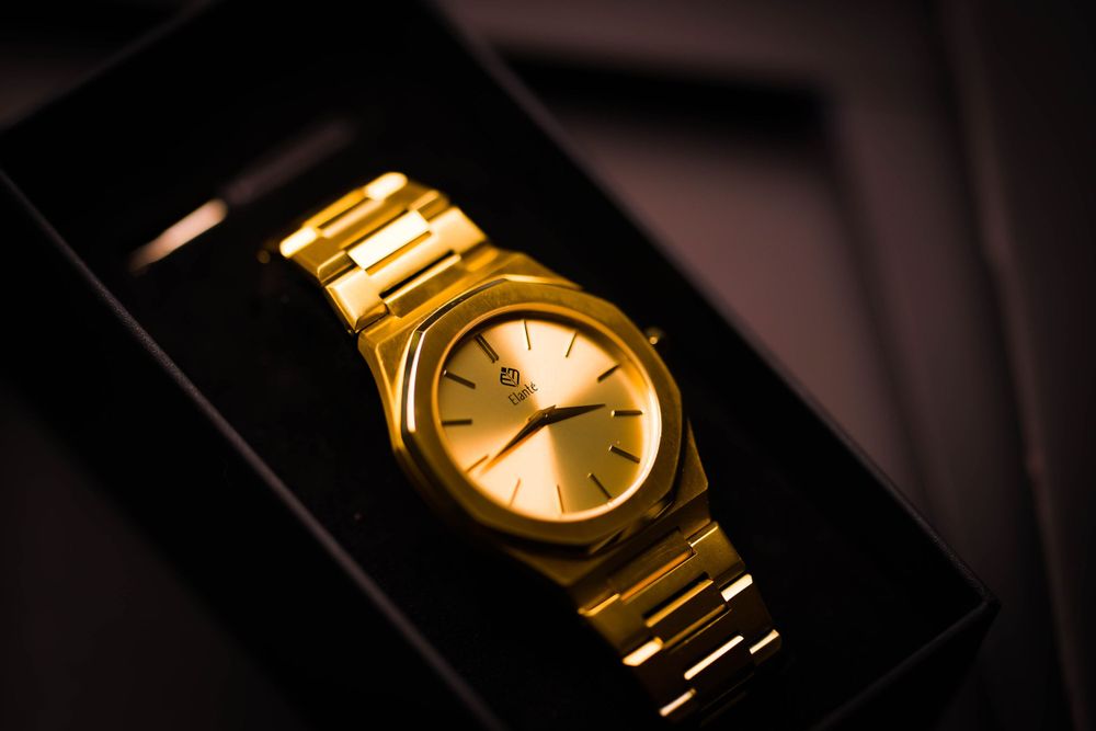 Bright gold watch in its case