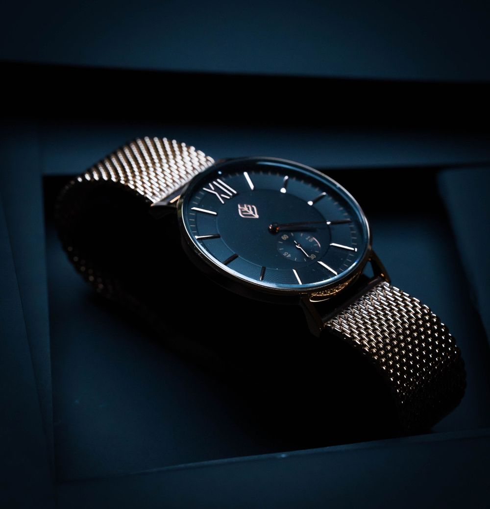 Silver wrist watch named the Osiris on black product shoot set