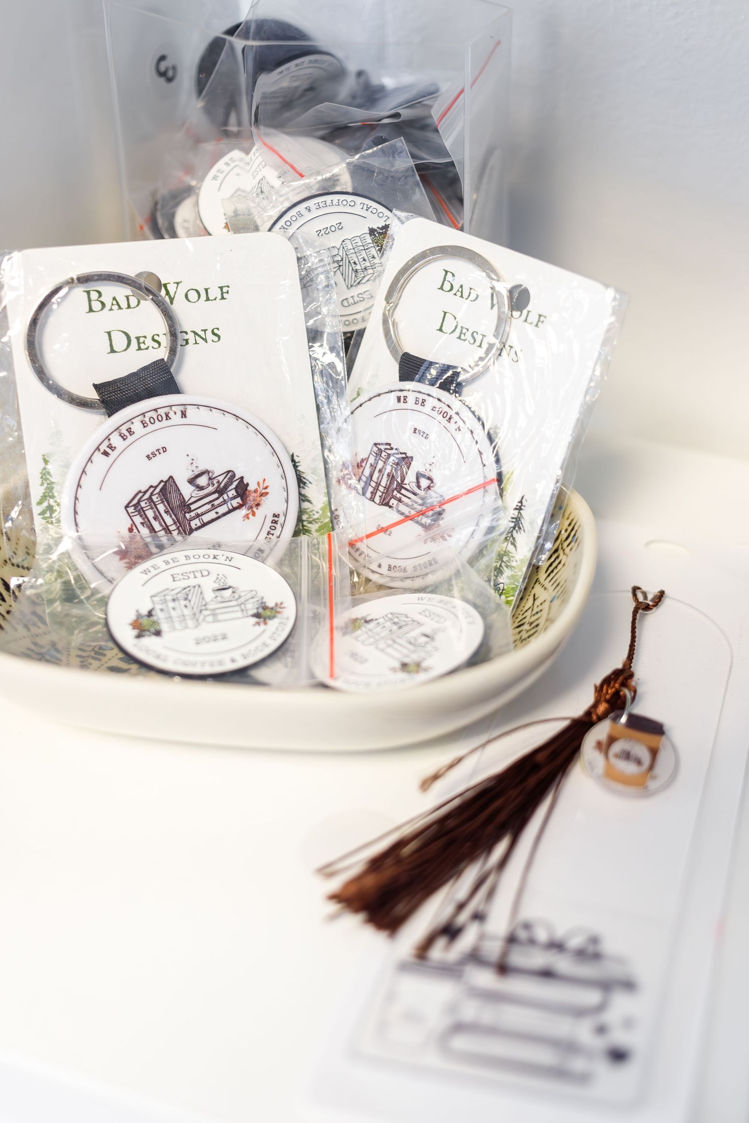 Bad Wolf Designs merchandise displayed in a white ceramic bowl with decorative tassels.