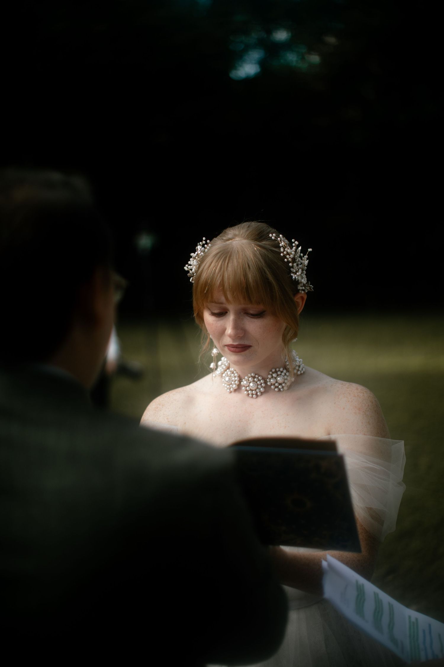 Artistic wedding portrait with natural sunlight creating a dreamy atmosphere.