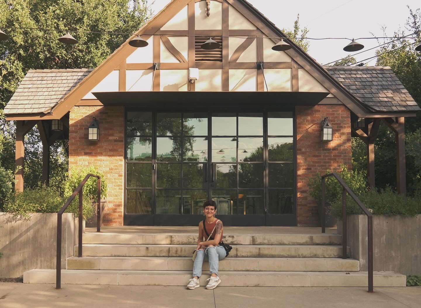 Modern rustic building with large glass windows and timber frame details.