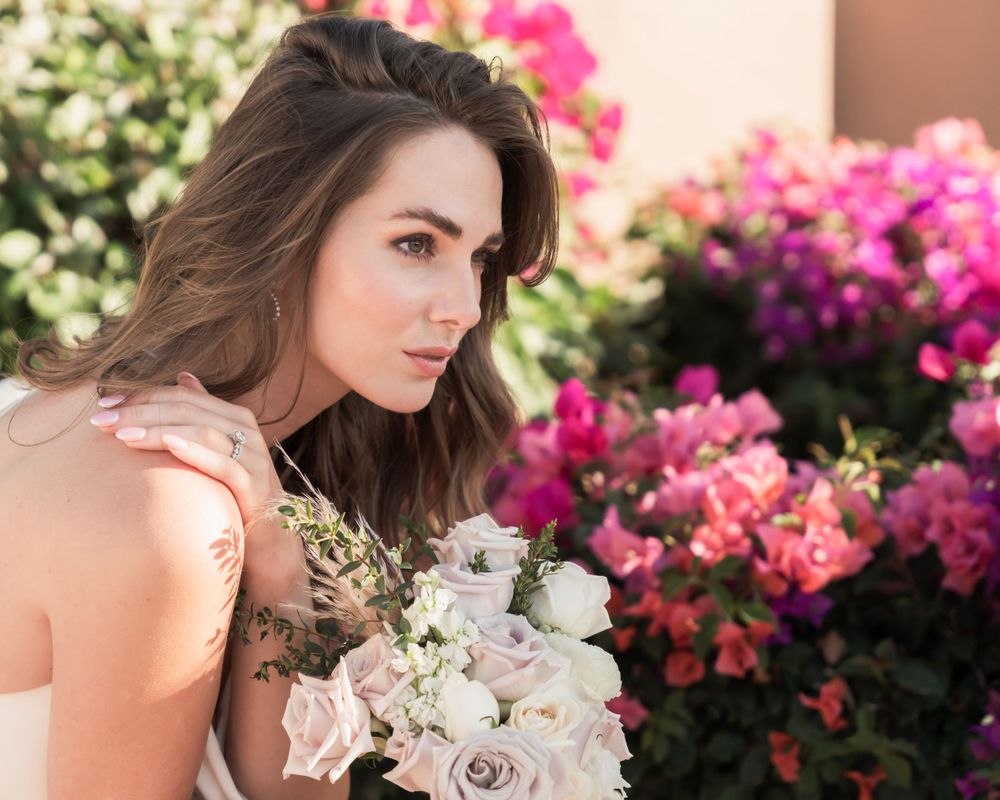 Romantic portrait with pink bougainvillea and white rose bouquet.