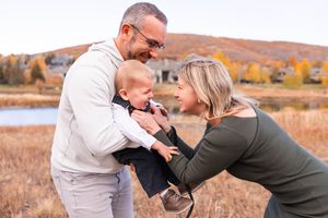 salt lake city utah family photographer, candid photo of a young family playing in park city mountains