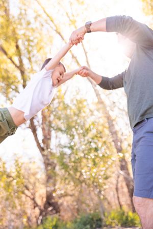 salt lake city utah family photographer, candid photo of a dad swinging his toddler
